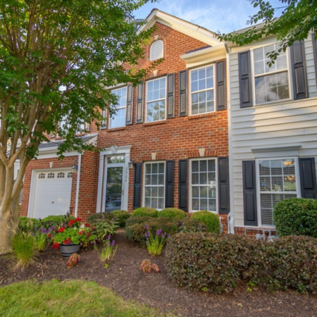 The front of an attached townhome with red brick